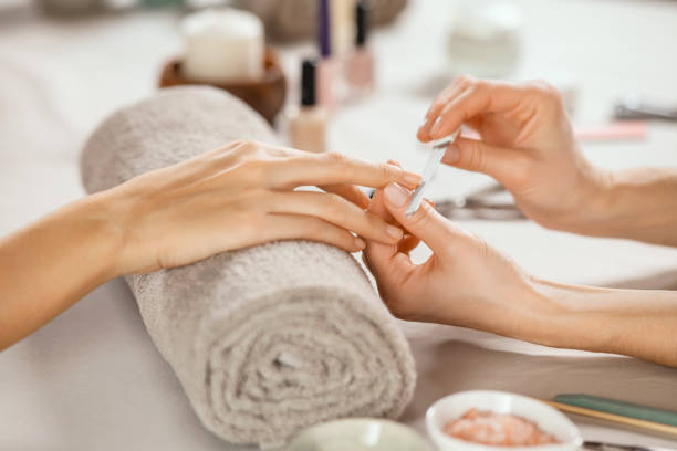 A women in salon receiving manicure