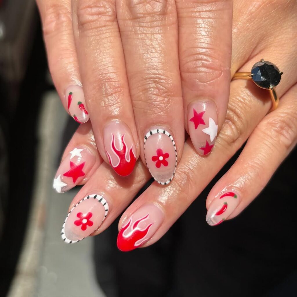 red and white flame nail design on oval nails