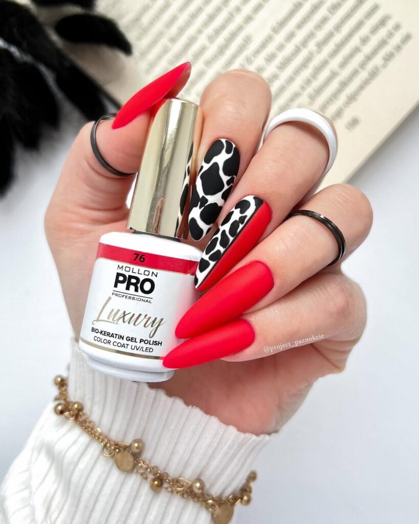 Red, black and white cow print nails in velvet texture