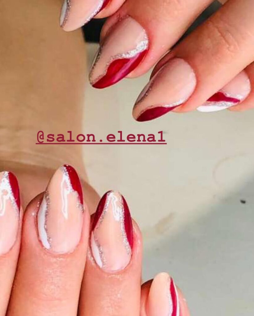 Negative space abstract nail art with red and white nail polish