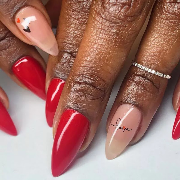 Dark hand with red stiletto nails having Black color love calligraphy 