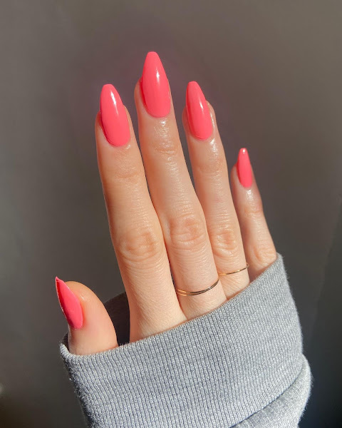 Coral color nail paint on hands