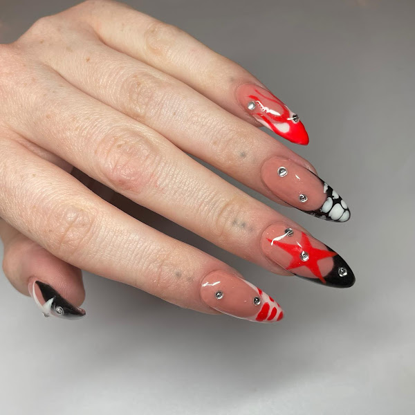 Red and black nail art design idea with croc, star and flame patterns