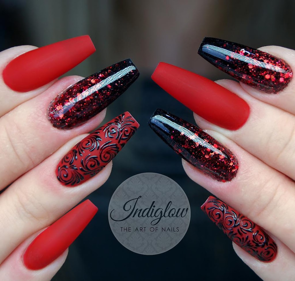 Long bright red matte nails along with blackish glitters 