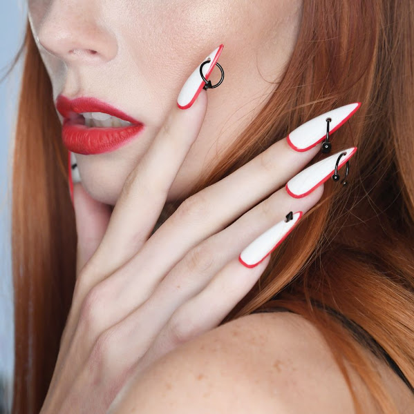 Stiletto shaped nails with red frame and black Pierce