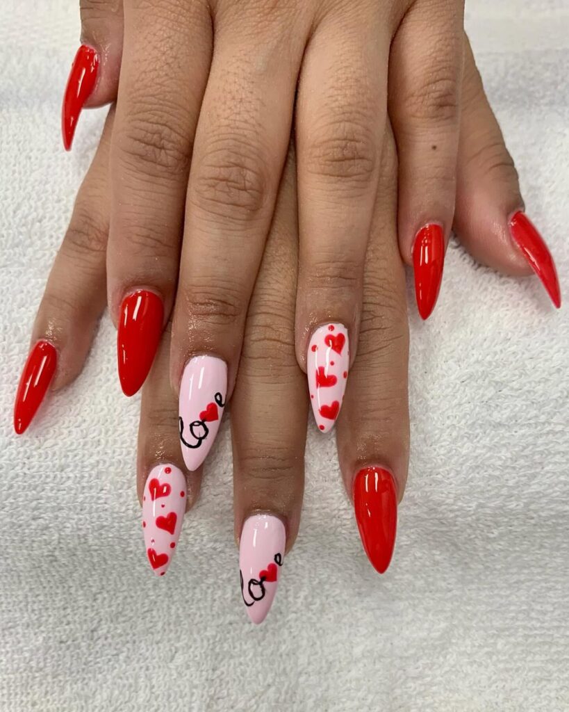 Valentines day themed red nails with hearts and written "Love"