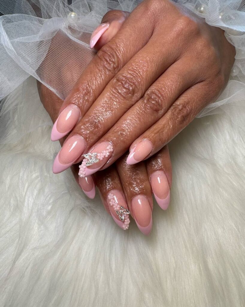 Baby pink french manicure along with a 3D butterfly accent 