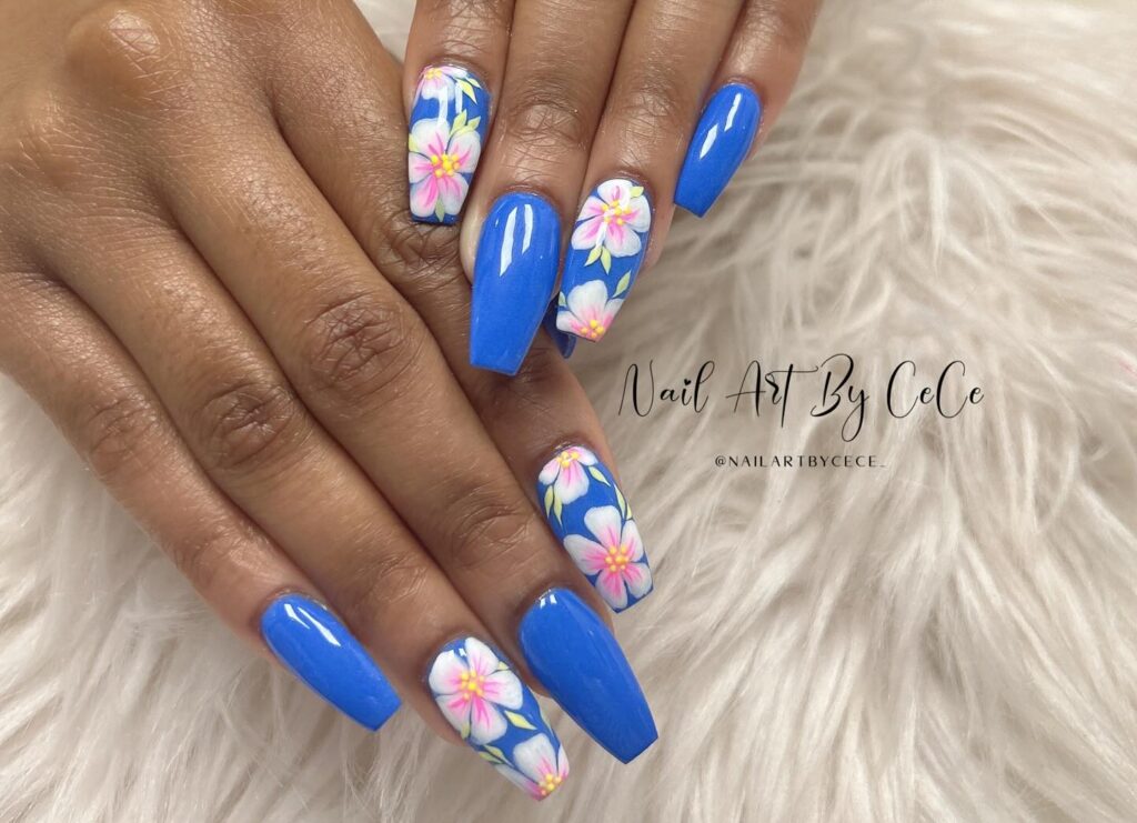 Glossy blue nexgen nails along with a design