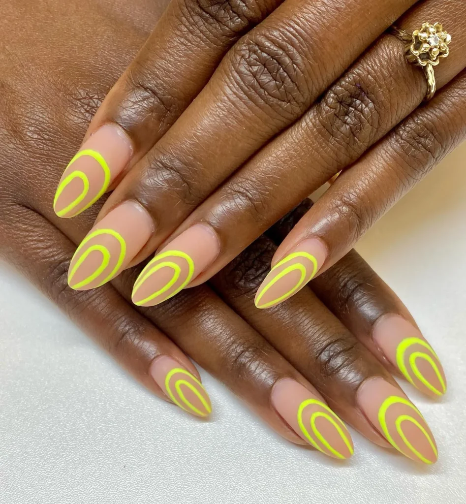 Bright matte yellow circles on nude almond nails