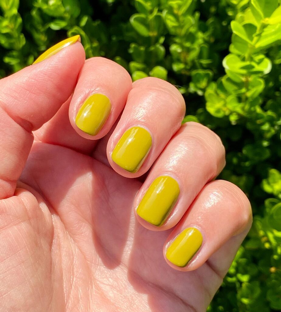 Short nails painted in simple Citrine yellow (greenish-yellow) shade