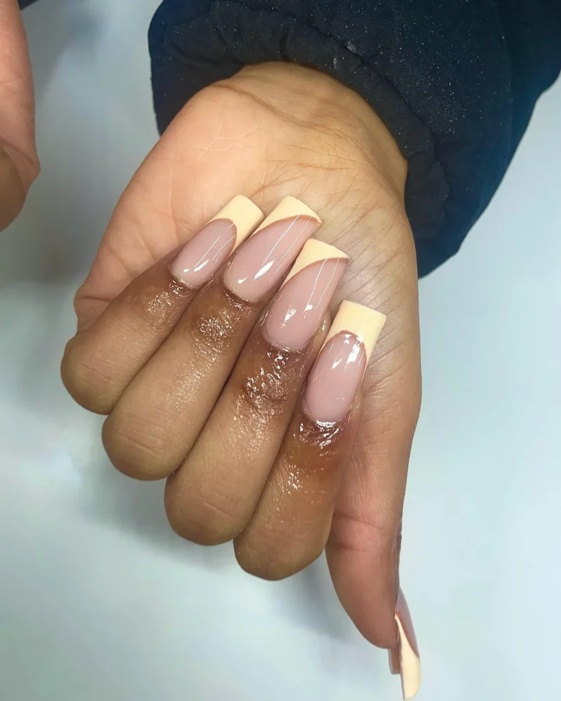 Diagonal french tip light yellow nails 