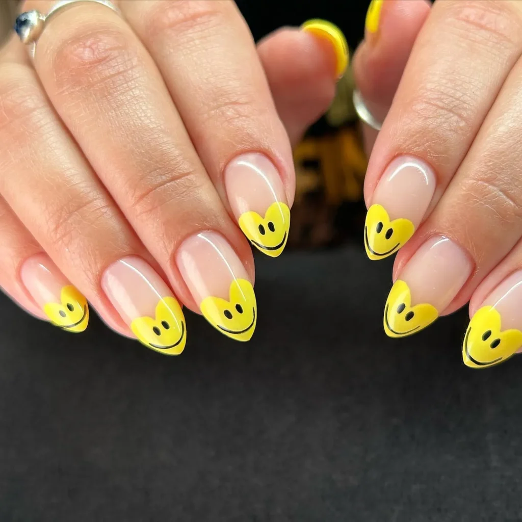 Nails with yellow emojis in heart shape