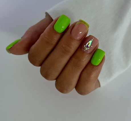 Bright neon green nail art along with rhinestones 