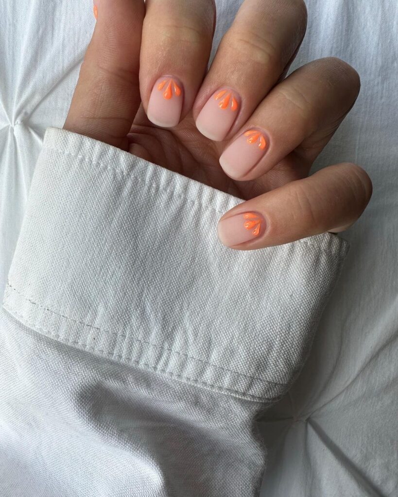 Simple short nails along with minimal floral nail art in orange color