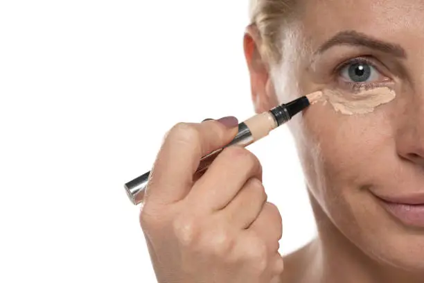 Women applying concealer