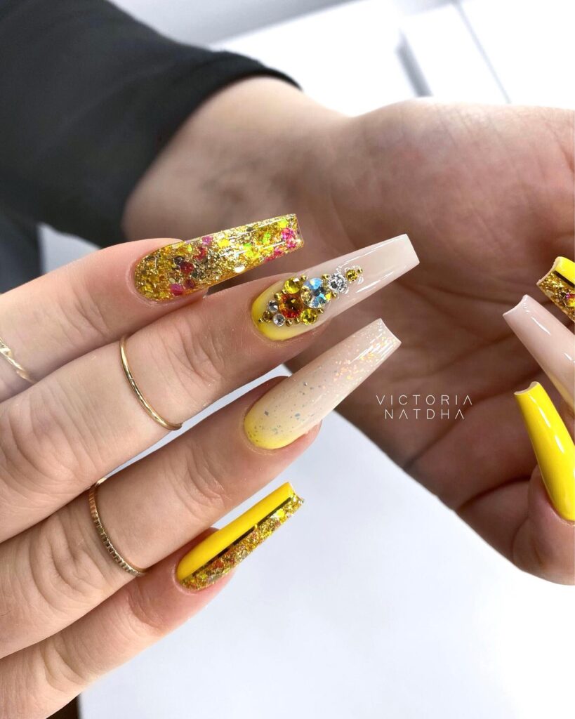 Yellow nail art with shining rhinestones