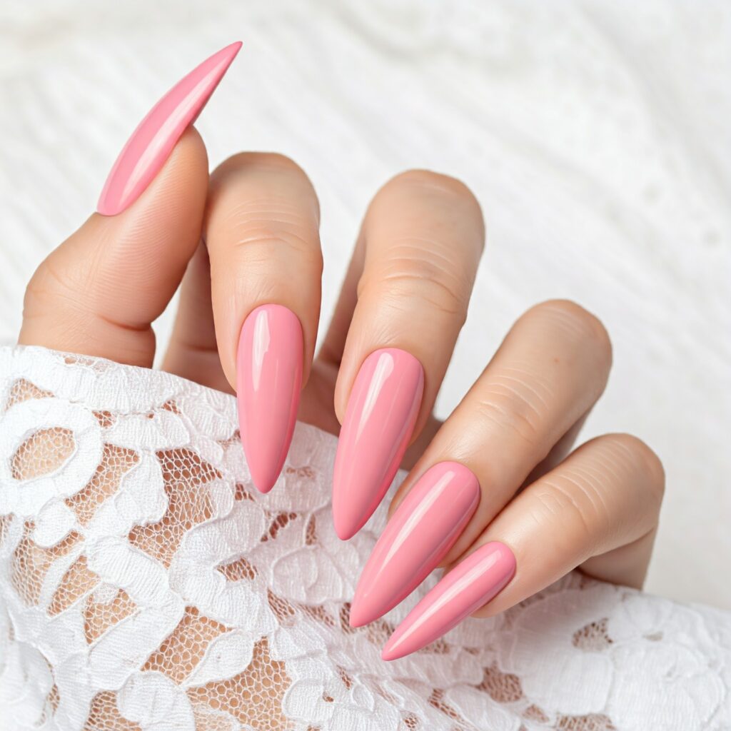 Stiletto nails painted in baby pink color