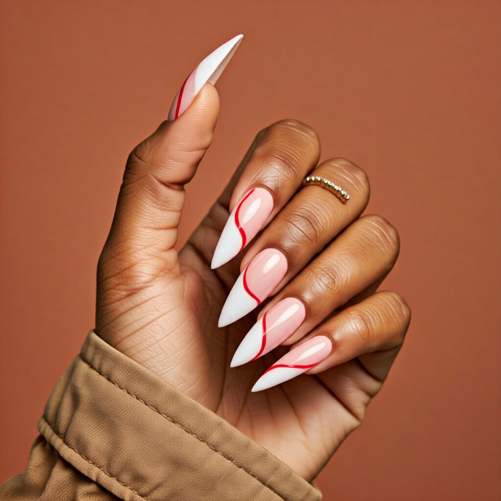 Black hand with stiletto nails featuring red and white nail art