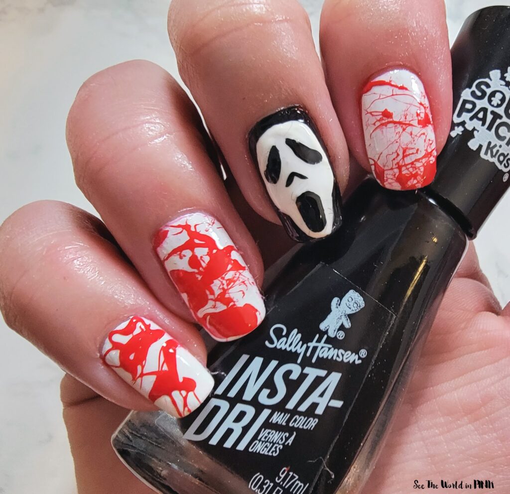 Blood splatter nail art with skull accent