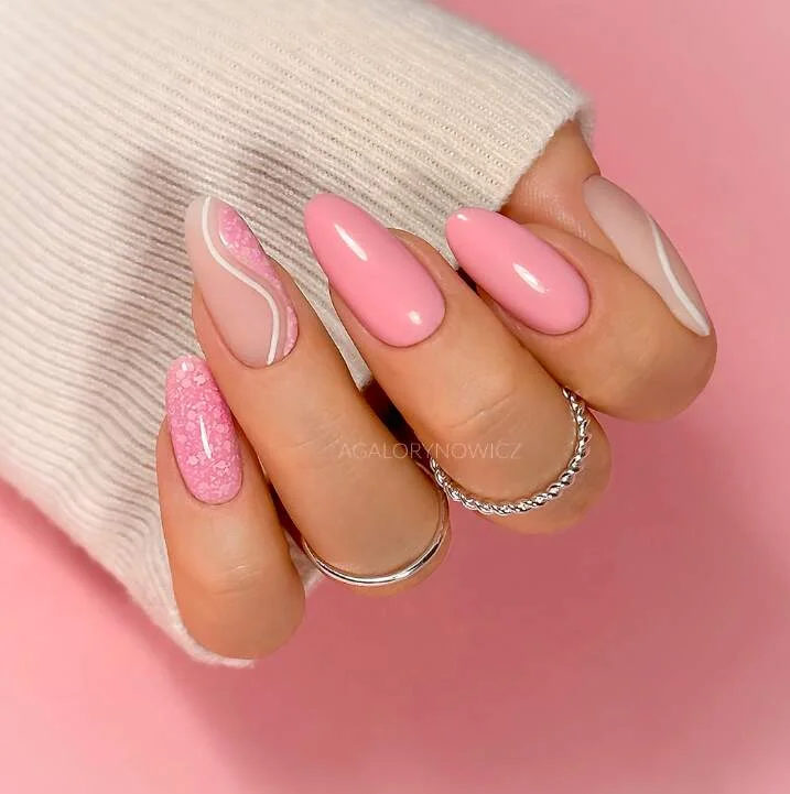 Pastel pink swirl nail design in oval shape