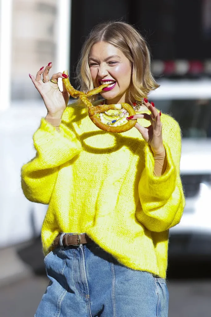 gigi hadid doing fun while her nails are painted in red