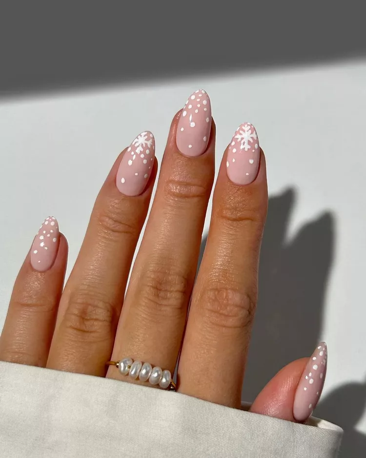 Pink and white snowflake nail art design for christmas