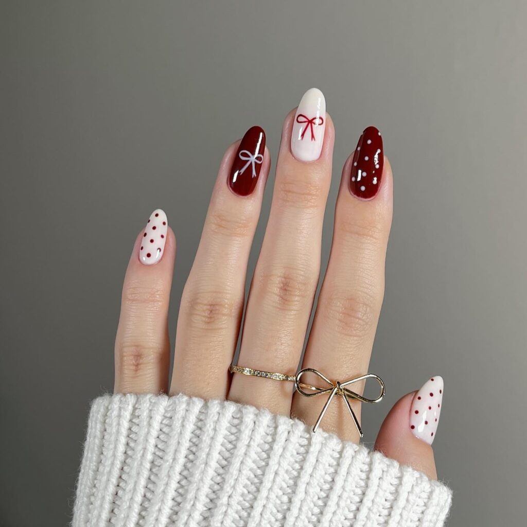 Burgundy and white coquette bow nails in oval shape