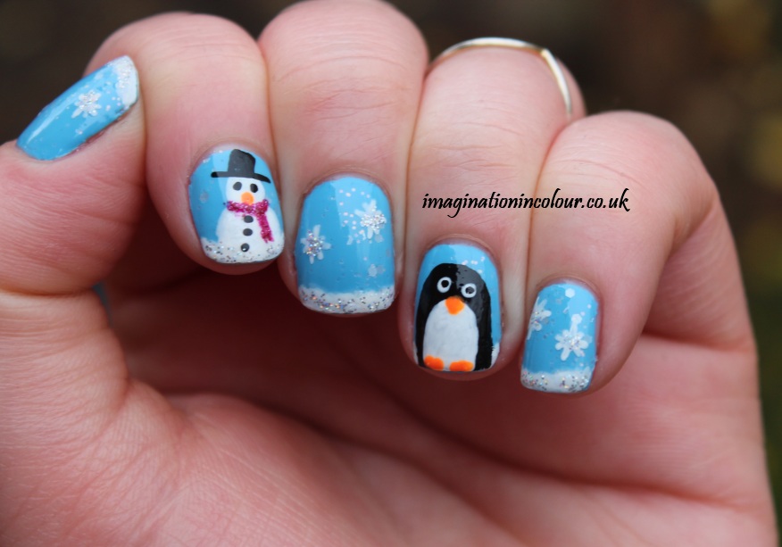 blue color Snowman and pengiun nail art on short nails