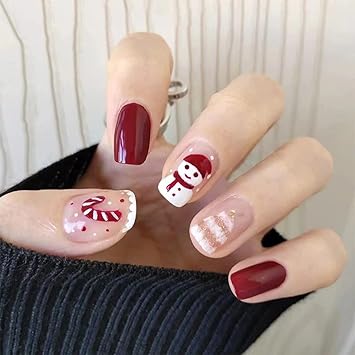 cute red and white candy cane nail art with a snowman accent