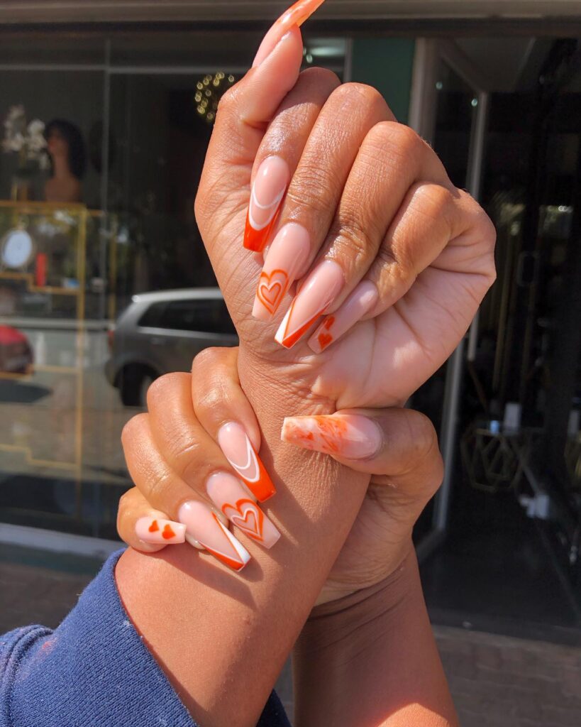 Orange and white heartbeat nail art