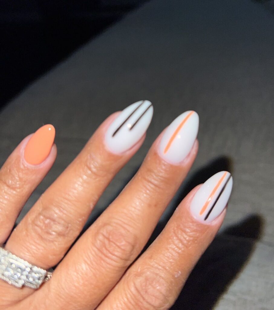 Orange and white line nail art