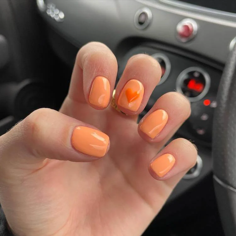 heart nail art with orange color
