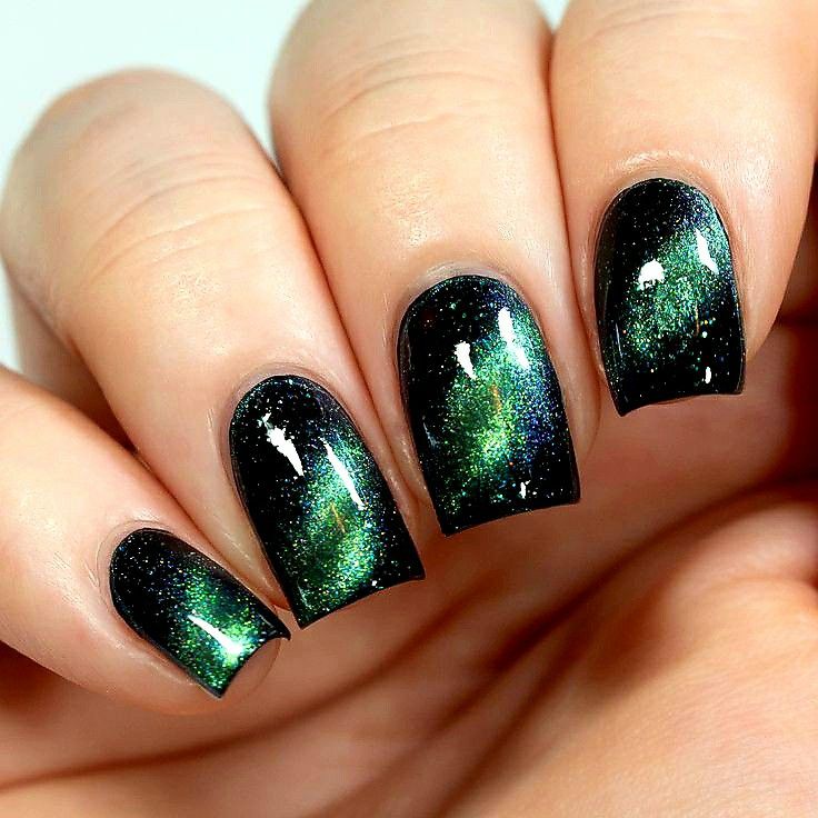 Green and black galaxy nails