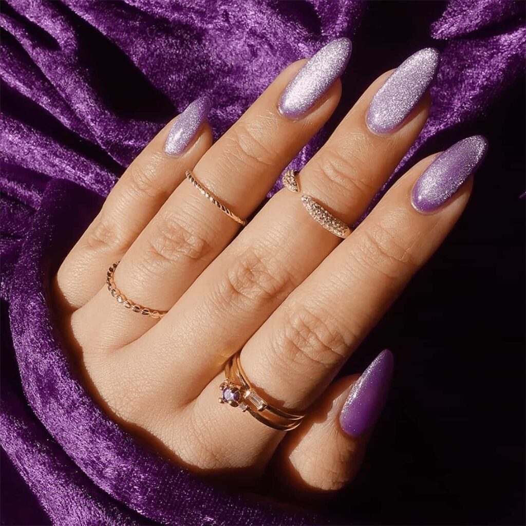 Almond-shaped light lavender purple nails with a luxurious crushed velvet shimmer effect