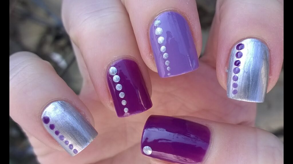 Block design nails with solid purple and metallic silver, featuring vertical lines of contrasting dots
