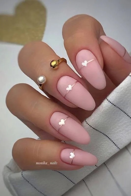 Matte pink nails with heart accents