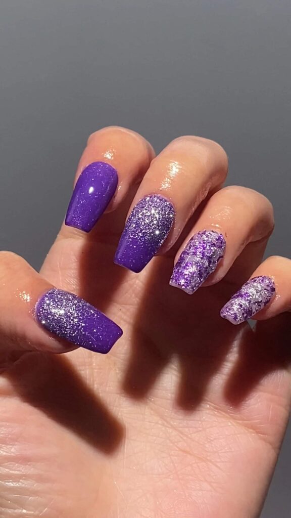 Mix and match coffin-shaped nails with solid purple, silver glitter, and shattered-glass effect on accent nails