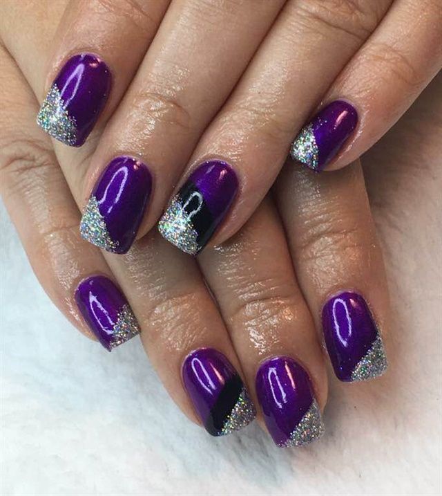 Vibrant purple nails with diagonal silver glitter stripes, some featuring a black stripe for contrast