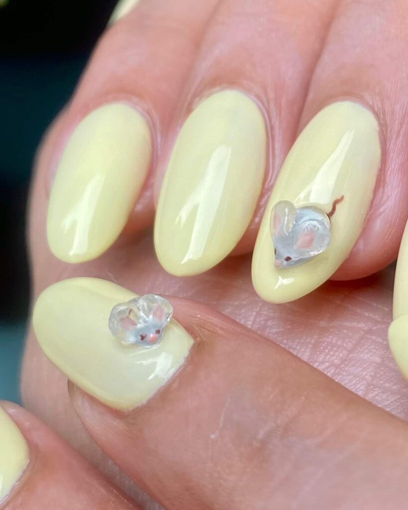 Yellow nails with 3D mouse animal nail art.