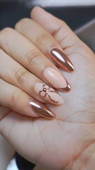 rose gold almond nails with bow accent