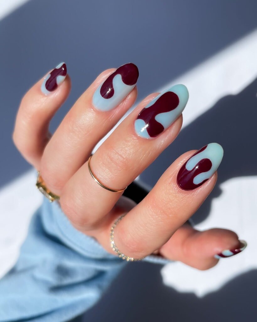 light Blue manicure with burgundy swirls